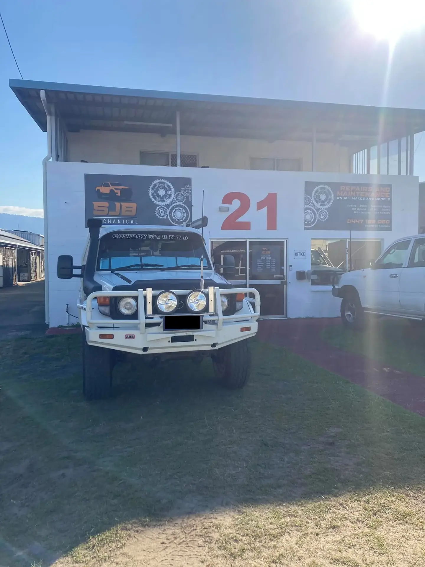 The SJB Mechanical workshop frontage at 21 Hannam St, Cairns, with a white 4WD parked out front